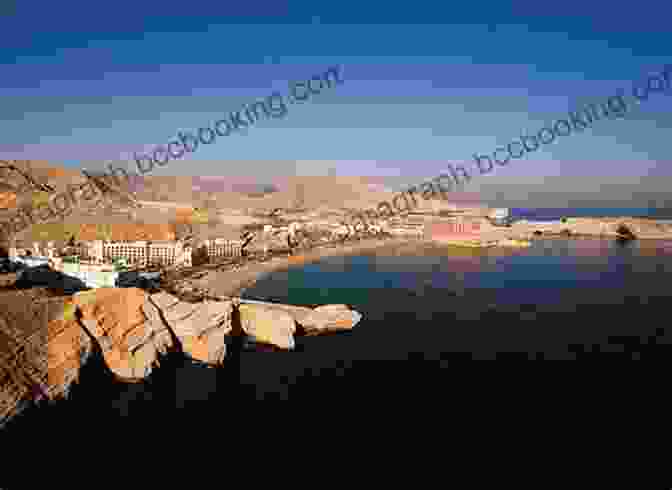 Panoramic View Of Muscat From The Al Jissah Mountains, With The City's White Buildings And Turquoise Waters In The Foreground And The Rugged Peaks Of The Hajar Mountains In The Background. Muscat ( CG Bradt Travel Guides (City Guides))